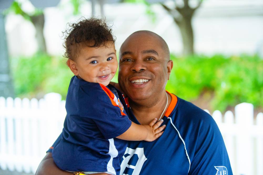 Man smiling with boy at Comerica Park event